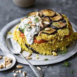 Buchcover „Deftig vegan Orient“ mit verschiedenen orientalischen Gerichten, darunter Hummus, Fladen und Gemüse.