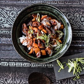 Buchcover „Deftig Vegan Asien“ mit großer Suppenschale, Essstäbchen und grünem Getränk auf dunklem Hintergrund.